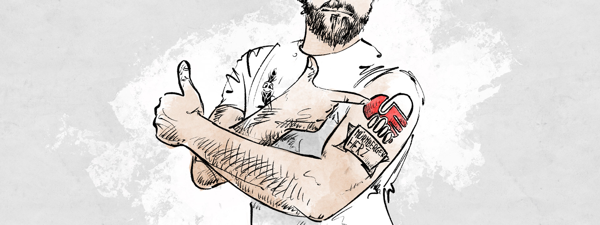 Ein Mann mit vielen Tattoos zeigt den Daumen nach oben.